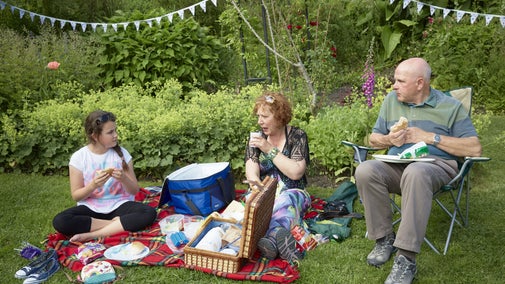 Visitors enjoying a picnic in a summer garden
